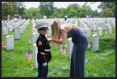 Memorial Day Weekend 2017 - Section 60 Brittany Jacobs fixes her son, Christian's, medals on his Marine uniform on Memorial Day at Arlington National Cemetery, Arlington, Va., May 29, 2017. Brittany and Christian come to Section 60 every year to honor Christian's father. (U.S. Army photo by Elizabeth Fraser / Arlington National Cemetery / released)